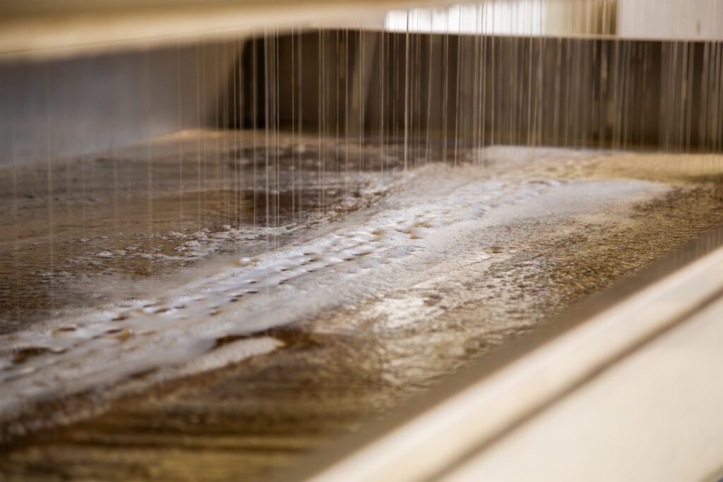 A viscus ice wine is being pressed from frozen grapes.